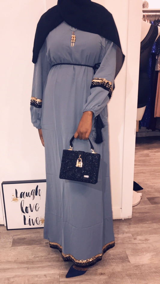 Elegant woman wearing the Intizar Maxi Dress Clearance FINAL Sale with stylish black accessories