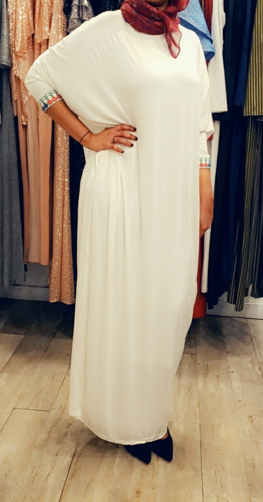 Woman wearing white Cotton Butterfly Dress FINAL SALE with loose fit and colorful cuff details