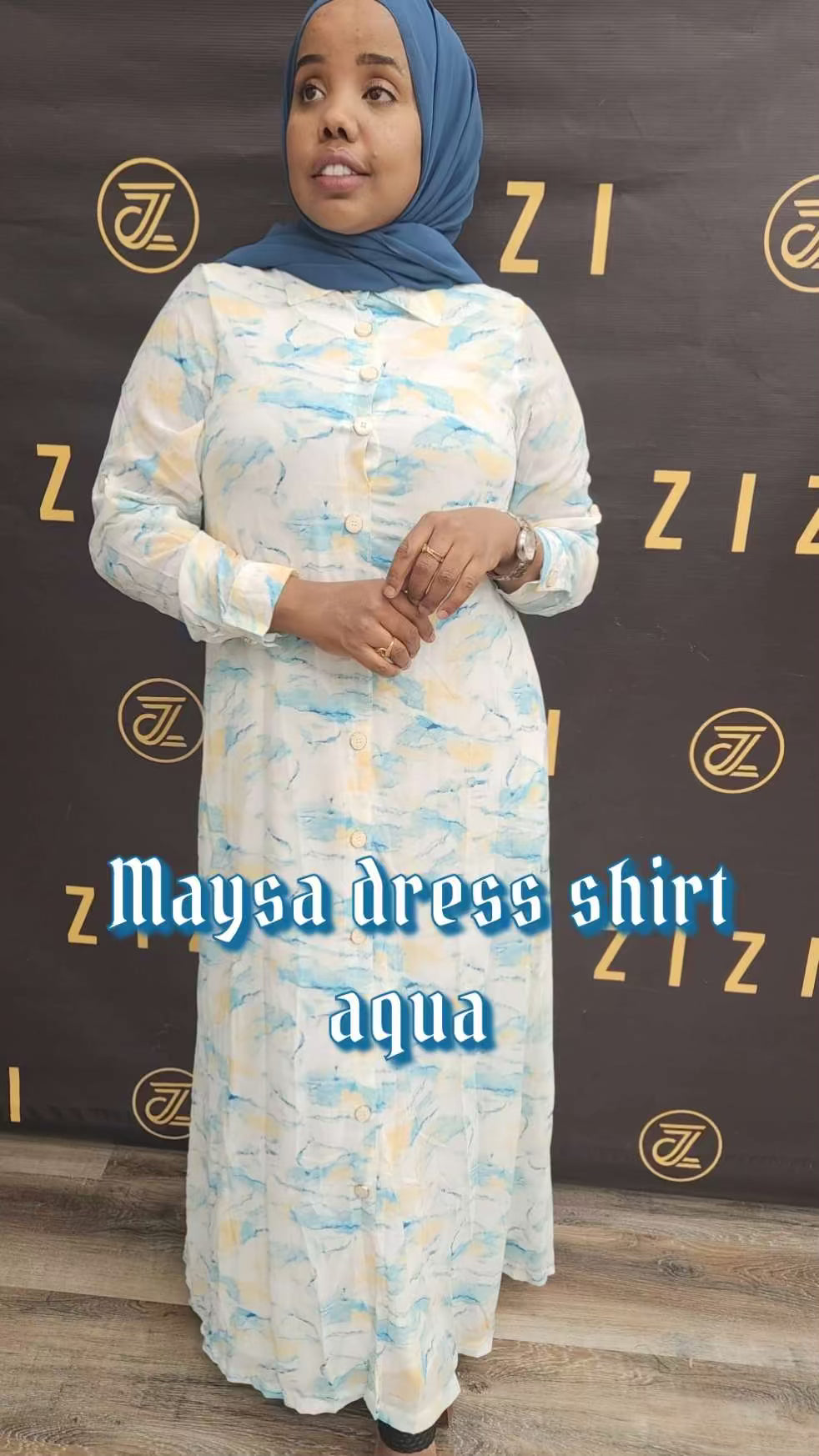 Woman wearing ZIZI Boutique Maysa Print Dress maxi dress in aqua with long sleeves and floral pattern