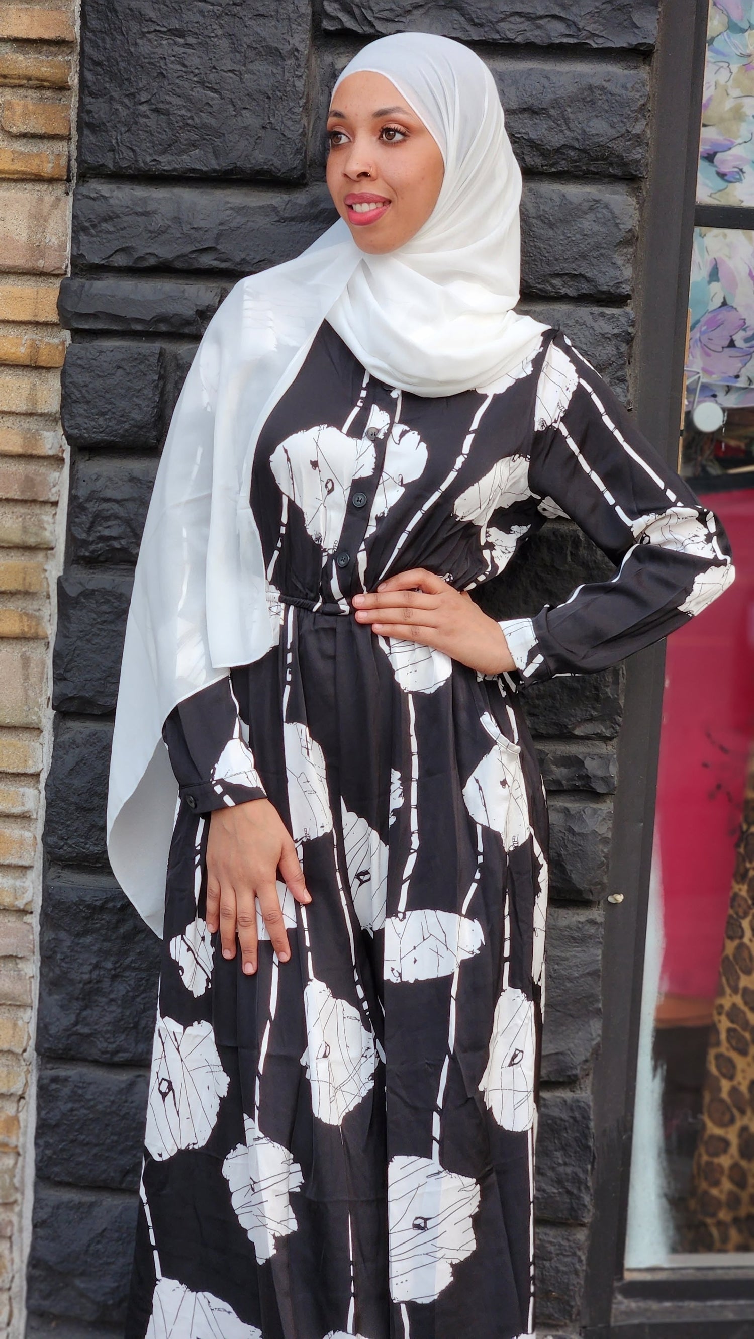 Brown plaid print dresses on mannequins in a clothing store showcasing various styles