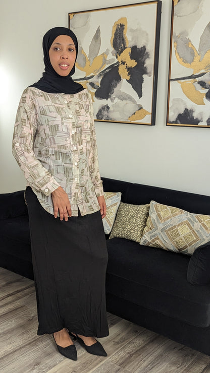 Woman wearing ZIZI MIDI Print Dress Shirt Blocks with abstract block pattern and black long skirt