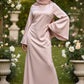 Woman wearing a pale pink Zalina Satin Maxi Dress from ZIZI Boutique with wide bell sleeves and a colorful hijab