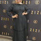 Woman wearing black Hodan Lace Maxi Dress from ZIZI Boutique with button-down front and long sleeves