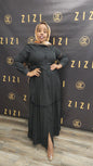 Woman wearing black Hodan Lace Maxi Dress from ZIZI Boutique with button-down front and long sleeves