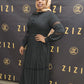 Woman wearing black Hodan Lace Maxi Dress from ZIZI Boutique with lace details on sleeves and flowing skirt