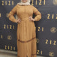 Woman wearing a brown Hodan Lace Maxi Dress from ZIZI Boutique with full sleeves and button details