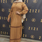 Woman wearing Hodan Lace Maxi Dress in brown by ZIZI Boutique with long sleeves and lace details