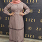 Woman wearing a Hodan Lace Maxi Dress in muted mauve color standing against ZIZI Boutique backdrop