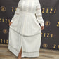 Woman wearing white Hodan Lace Maxi Dress from ZIZI Boutique with button-down front and lace details