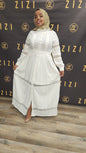 Woman wearing white Hodan Lace Maxi Dress from ZIZI Boutique with button-down front and lace details