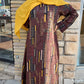 Woman wearing Zoraa Summer Print Maxi Dress with geometric patterns and yellow headscarf standing outdoors