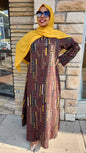Woman wearing Zoraa Summer Print Maxi Dress with geometric patterns and yellow headscarf standing outdoors