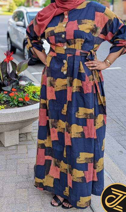 Woman wearing ZZ Linen Print Dress Blocks Print with button front and belt from ZIZI Boutique