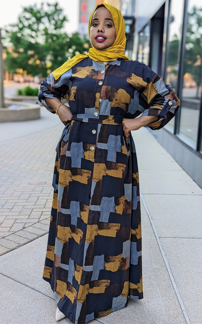 Woman wearing ZZ Linen Print Dress Blocks Print by ZIZI Boutique with abstract block design in black, brown, and gray colors