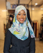 Woman wearing a Chiffon Print Hijab Turquoise/Lime/Plum Ink Blots with floral pattern and wrap style