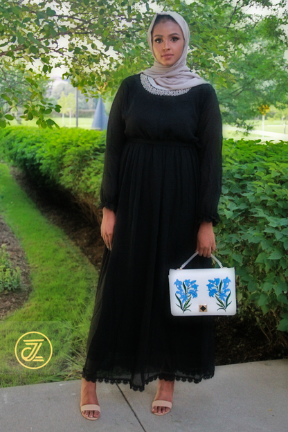 Elegant Cleopatra Chiffon Maxi Dress FINAL SALE worn by a model with a stylish handbag in a lush outdoor setting