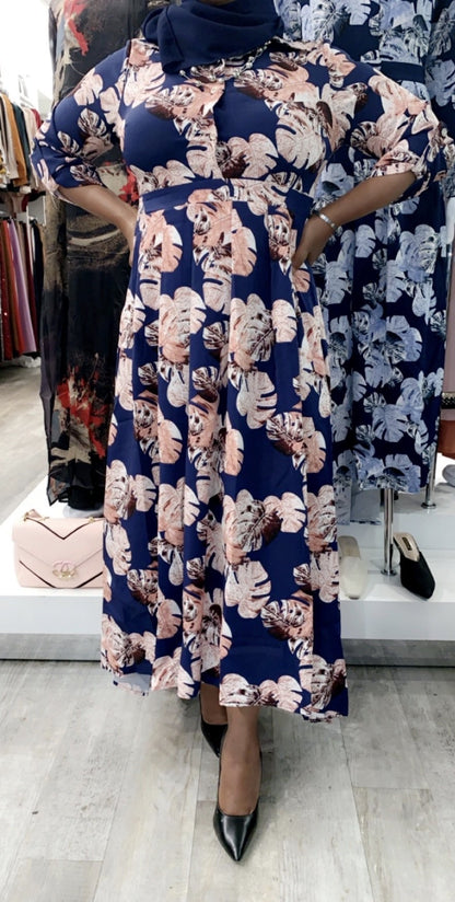 Model wearing a Floral High Low Maxi Dress featuring vibrant floral patterns in blue and pink