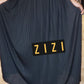 High waisted women's maxi pleated skirt in black worn with black top and boots