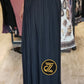 High waisted women's maxi pleated skirt in black worn with long sleeve top and boots