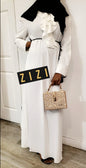 Elegant Intizar Ruffle Maxi Dress in white with a stylish belt and handbag for a chic look
