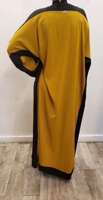Back view of Qalanjo Design Abaya Eid Collection in mustard yellow and black, perfect for festive occasions
