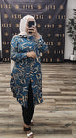 Woman wearing a blue Swirls Print Dress Shirt MIDI from ZIZI Boutique with white and beige swirl patterns
