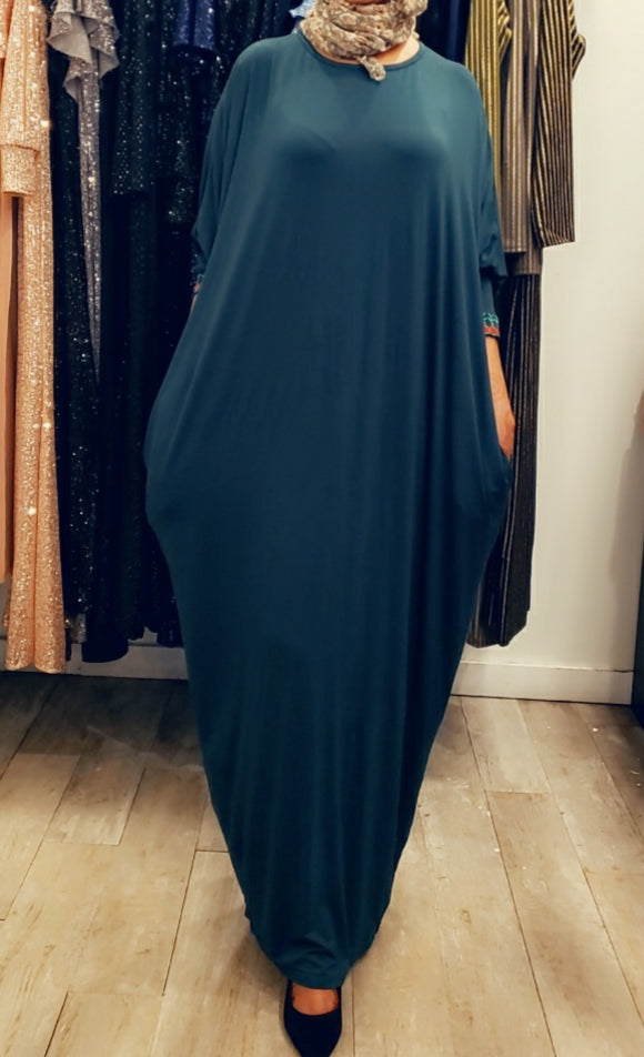 Woman wearing a teal Cotton Butterfly Dress - FINAL SALE from ZIZI Boutique with long sleeves and relaxed fit