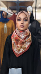 ZIZI XL Print Hijab - Burnt Orange Flower worn by woman with floral design and rich burnt orange border
