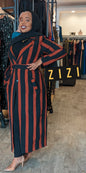 ZIZI Boutique long coat with black and rust vertical stripes worn by a woman in a boutique