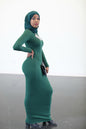 Elegant woman in green Bodycon Zipper Maxi Dress Shapewear ZIZI Boutique, showcasing a sleek silhouette.