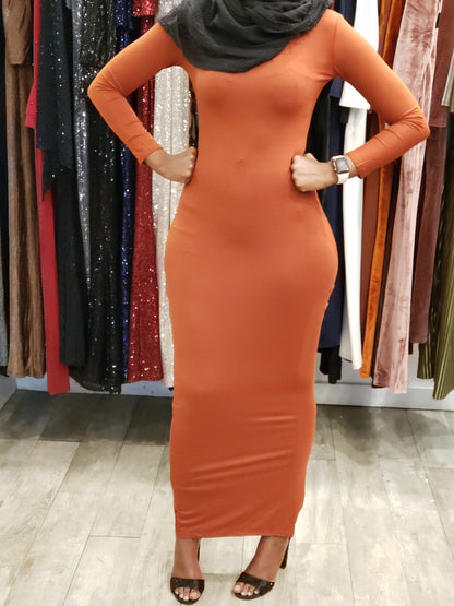 Model wearing Bodycon Zipper Maxi Dress Shapewear ZIZI Boutique in orange with long sleeves