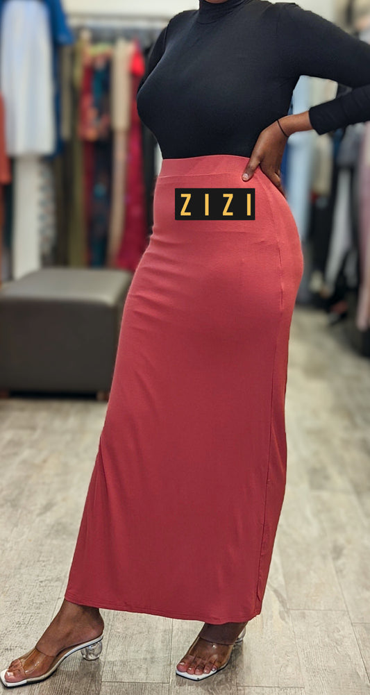 Woman wearing a ZIZI Boutique Essential Jersey Maxi Skirt in a stylish setting with a fitted black top