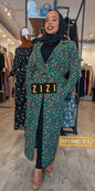 brand long coat with green and leopard print design worn by a woman in a store setting