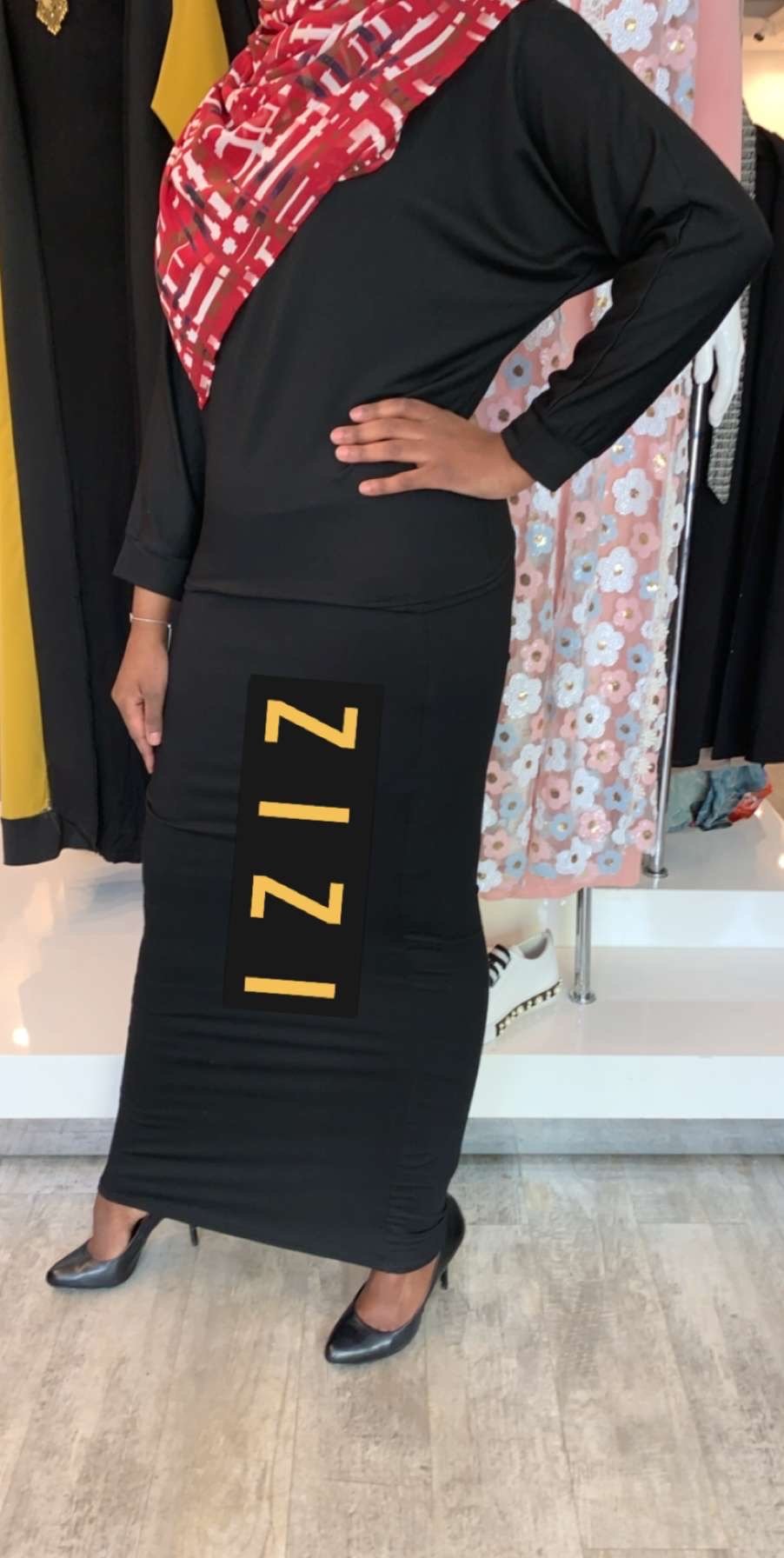 ZIZI light sweater and skirt set in black featuring bold yellow logo on skirt with long sleeves