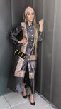 Woman wearing a Satin Silk Maxi Print Dress Shirt by ZIZI Boutique with black and brown pattern and button details
