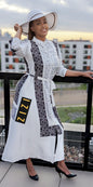 Woman wearing a Satin Silk Maxi Print Dress Shirt by ZIZI Boutique with black and white pattern and white hat