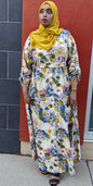 Woman wearing ZZ Linen Dess Multi Flowers Print dress with yellow hijab and black sandals at outdoor location